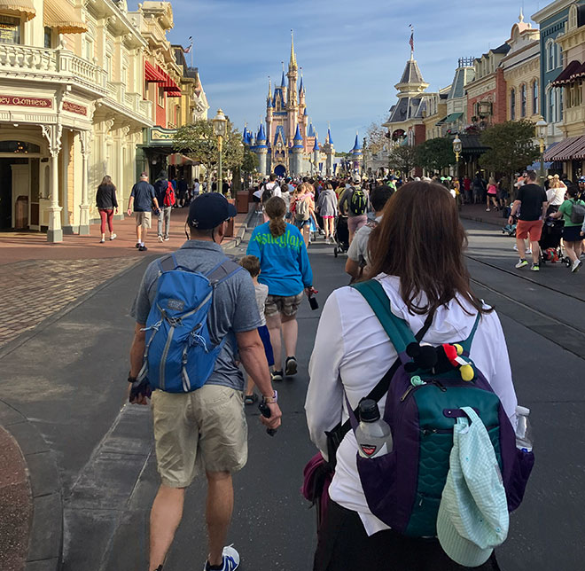 pushing a stroller down main street in the magic kingdom
